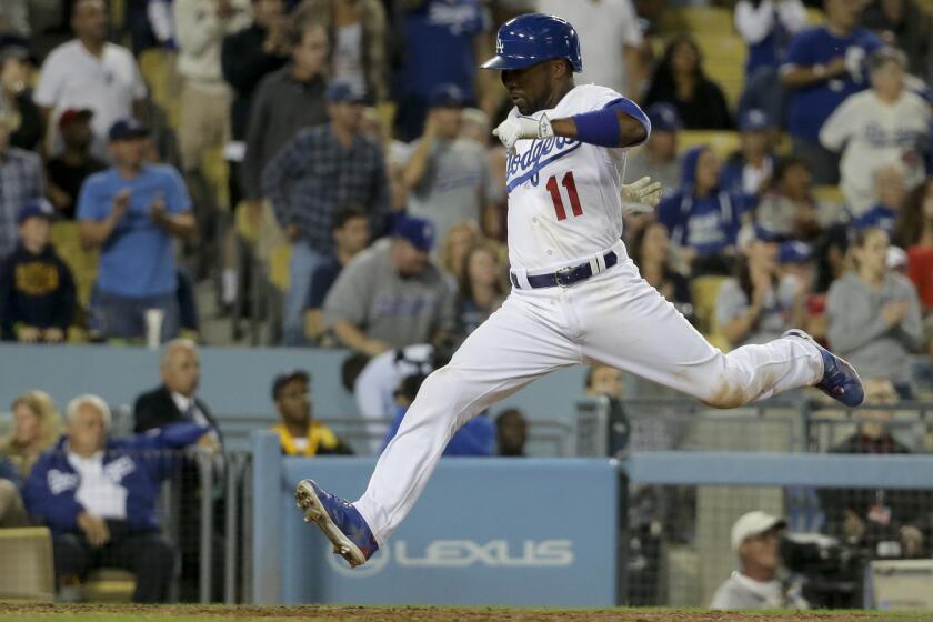 Dodgers shortstop Jimmy Rollins scores against his former team, the Phillies, on a double by Joc Pederson on July 6.