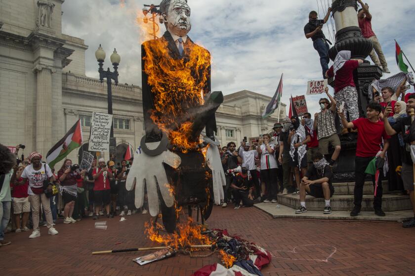 Pro-Palestinian demonstrators burn a US flag and a puppet of Israeli Prime Minister Benjamin Netanyahu at Union Station during a protest against Israeli Prime Minister Benjamin Netanyahu's visit to the USA in Washington DC on July 24, 2024. Activists staged multiple protests near the Capitol to protest Netanyahu's visit to Washington amid Israel's ongoing war against Hamas in Gaza. (Photo by Probal Rashid/Sipa USA)(Sipa via AP Images)