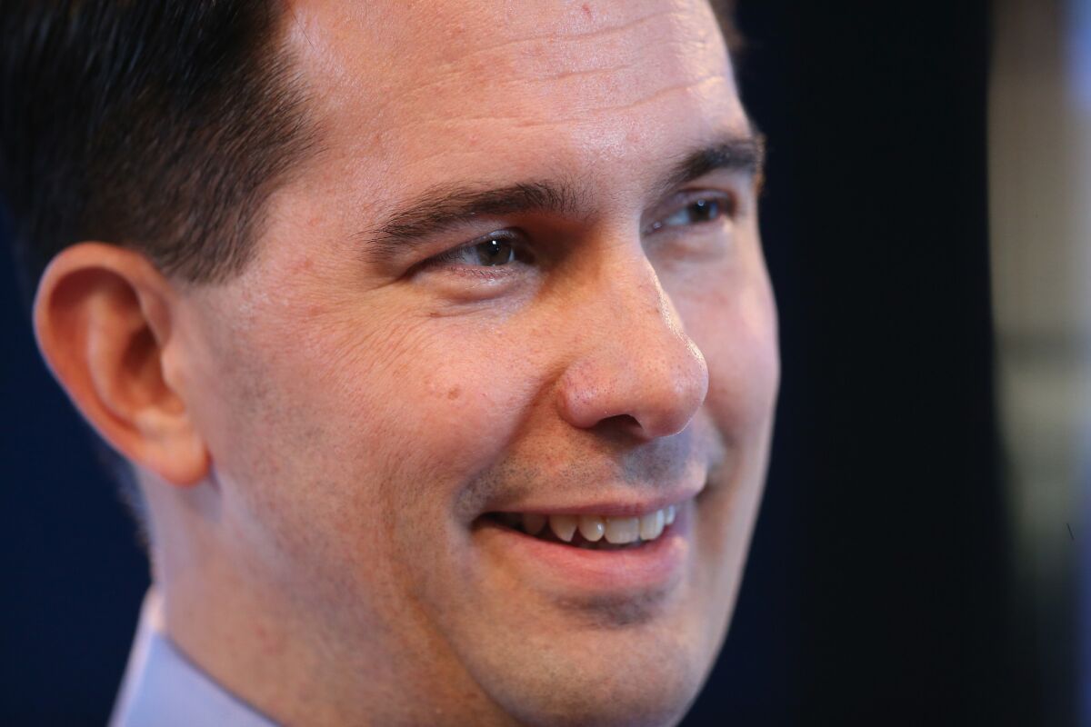 Wisconsin Gov. Scott Walker is a longtime proponent of voter ID requirements and signed Wisconsin's into law in 2011. Above, Walker in Iowa on March 7.
