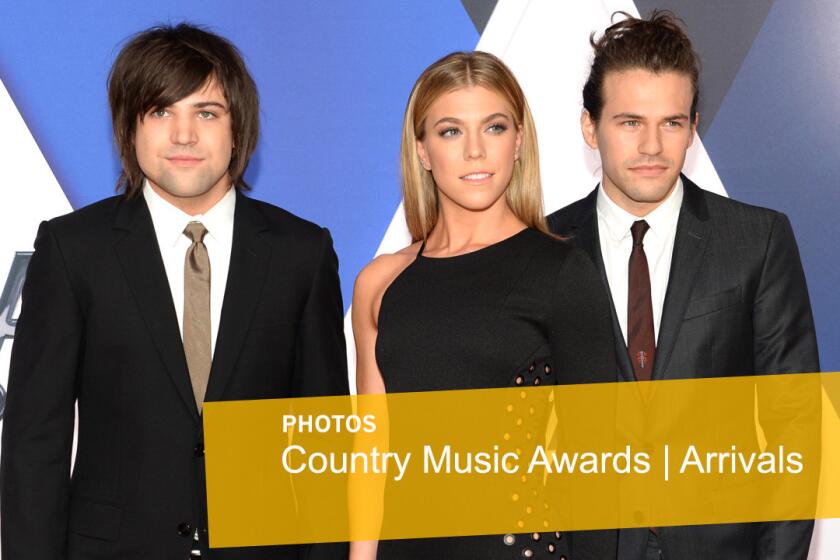 Neil Perry, left, Kimberly Perry and Reid Perry, of the Band Perry, arrive at the CMA Awards.