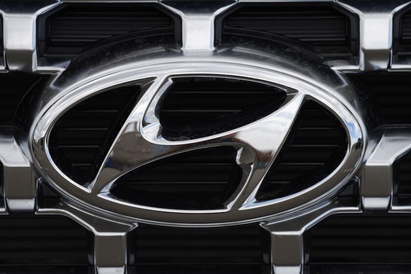 FILE - The Hyundai company logo is displayed Sunday, Sept. 12, 2021, in Littleton, Colo. Hyundai and Kia are telling owners, Friday, March 23, 2023 of over 571,000 SUVs and minivans in the U.S. to park them outdoors because the tow hitch harnesses can catch fire while they are parked or being driven. The Korean automakers are recalling the vehicles. (AP Photo/David Zalubowski, File)