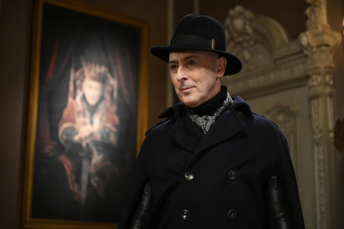 Alan Cumming, in a black hat and coat, in "The Traitors."