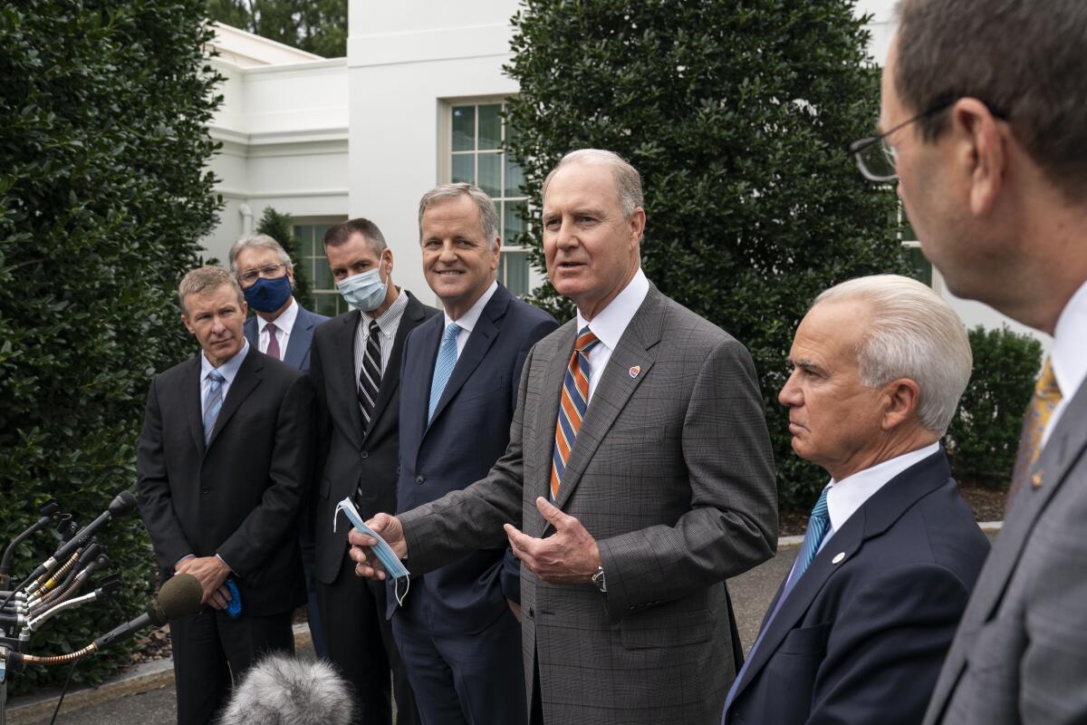 The chief executives of several U.S. airlines talk to reporters at the White House in 2020.