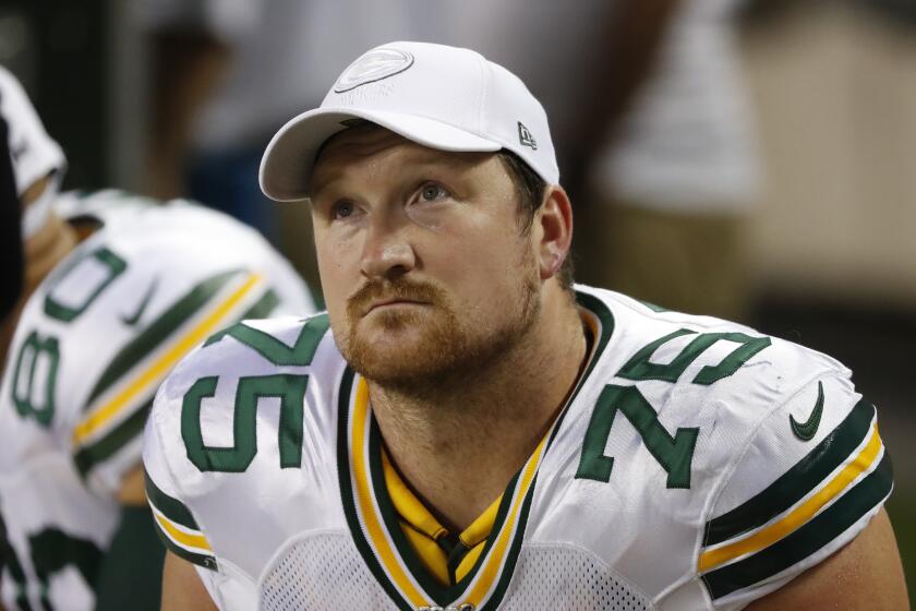 In this Sept. 5, 2019 file photo Green Bay Packers offensive tackle Bryan Bulaga sits on the bench during an NFL football game against the Chicago Bears in Chicago. By adding linebacker Christian Kirksey and offensive tackle Rick Wagner this week, the Packers signaled that they would be moving forward without two key veterans. That became apparent when longtime right tackle Bryan Bulaga agreed to terms with the Los Angeles Chargers. The Packers confirmed reports of his departure Wednesday, March 18, 2020 on the opening day of free agency. (AP Photo/Charles Rex Arbogast, file)