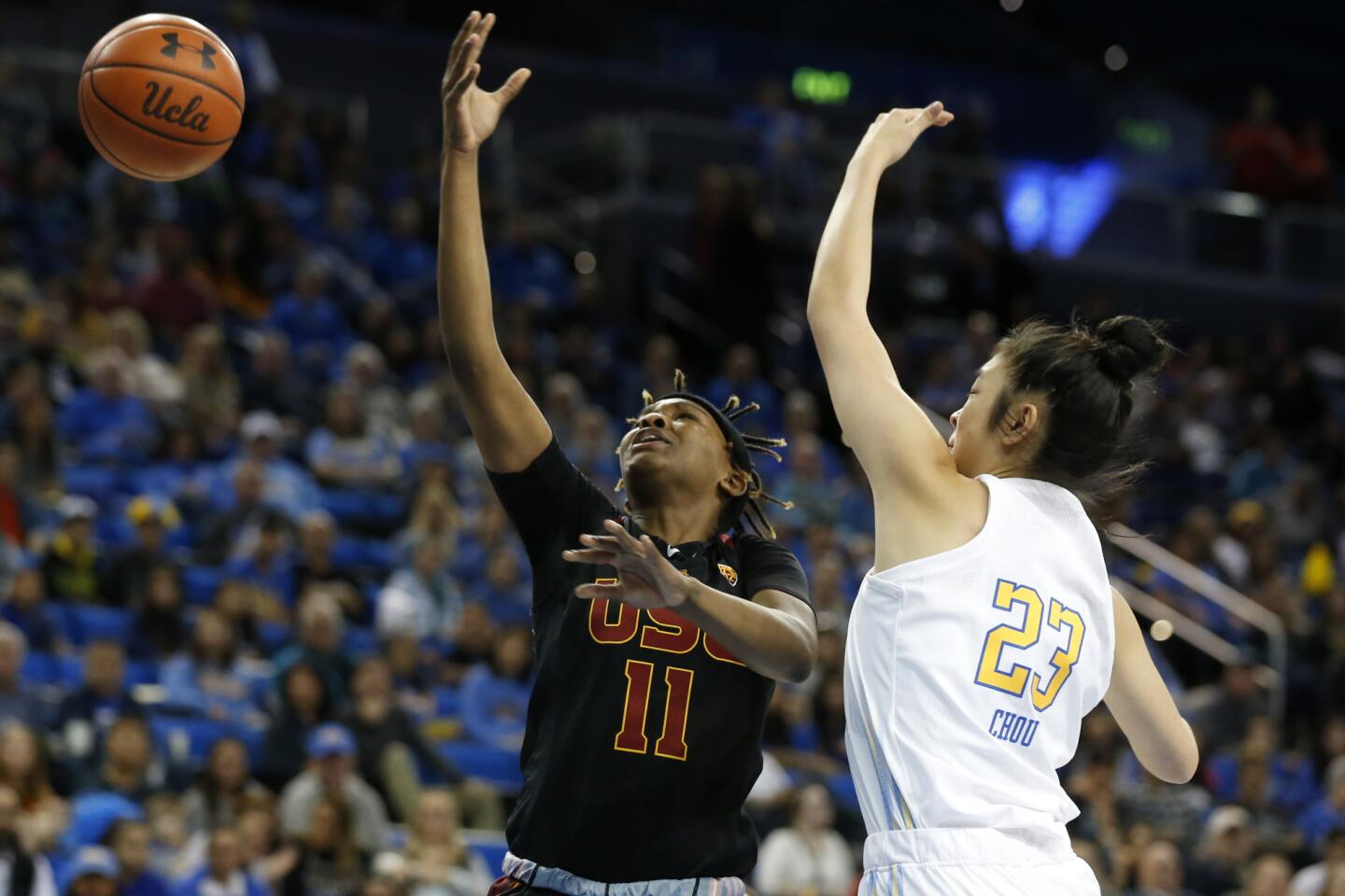 UCLA guard Natalie Chou (23) blocks a shot by USC guard Aliyah Jeune during the first half.