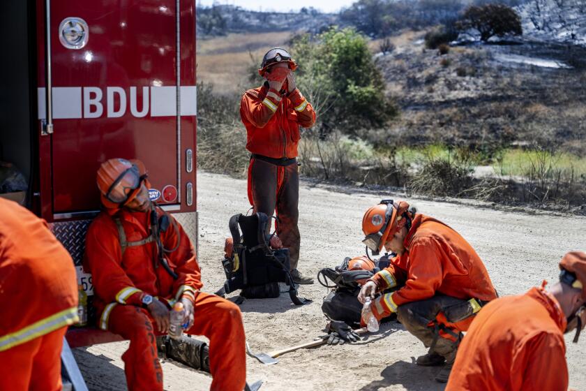 BEAUMONT, CA - JULY 16, 2023: Prado fire crews take a break from the 105 degree heat while putting out hotspots at the Rabbit fire on July 16, 2023 in Beaumont, CA. (Gina Ferazzi / Los Angeles Times)