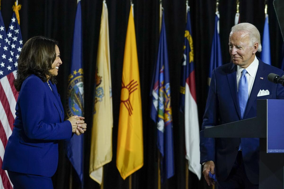 Joe Biden invites Sen. Kamala Harris  to the stage to deliver remarks at the Alexis Dupont High School in Wilmington, Del.