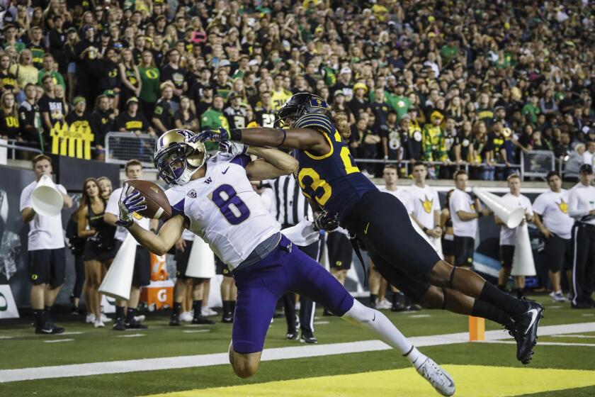 Washington wide receiver Dante Pettis (8) catches a one-handed pass with pressure from Oregon defensive back Malik Lovette (23), who was called for pass interference on the play.