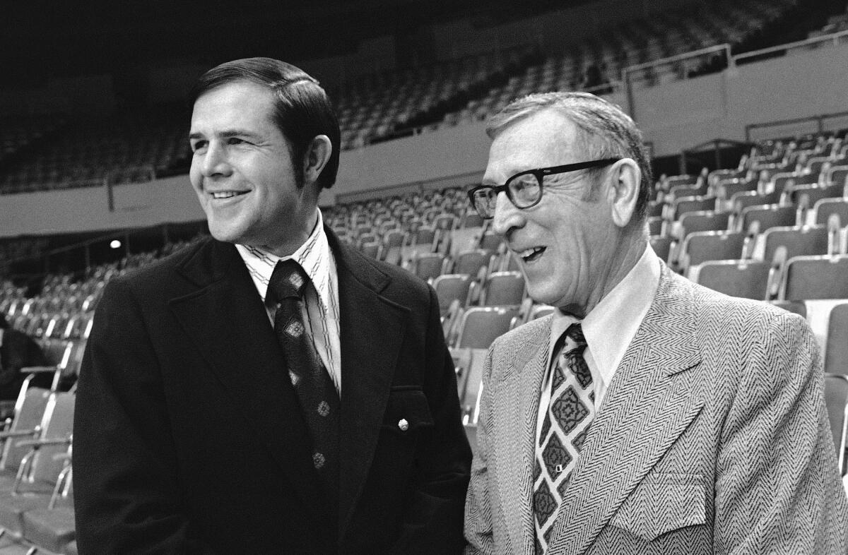 UCLA coach John Wooden, right, and Louisville coach Denny Crum share a laugh in March 1972.