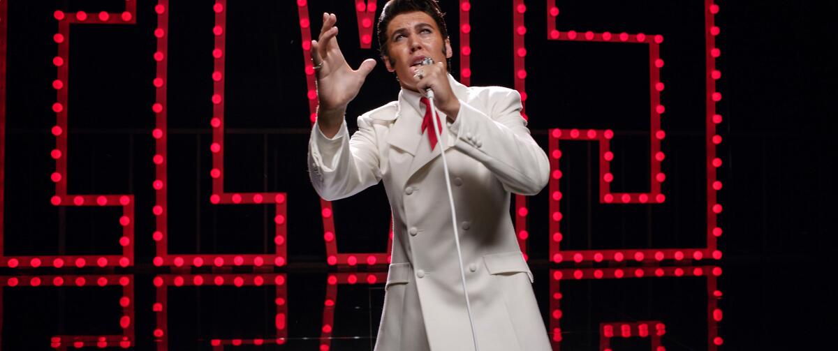 Austin Butler sings onstage in a scene from "Elvis." 