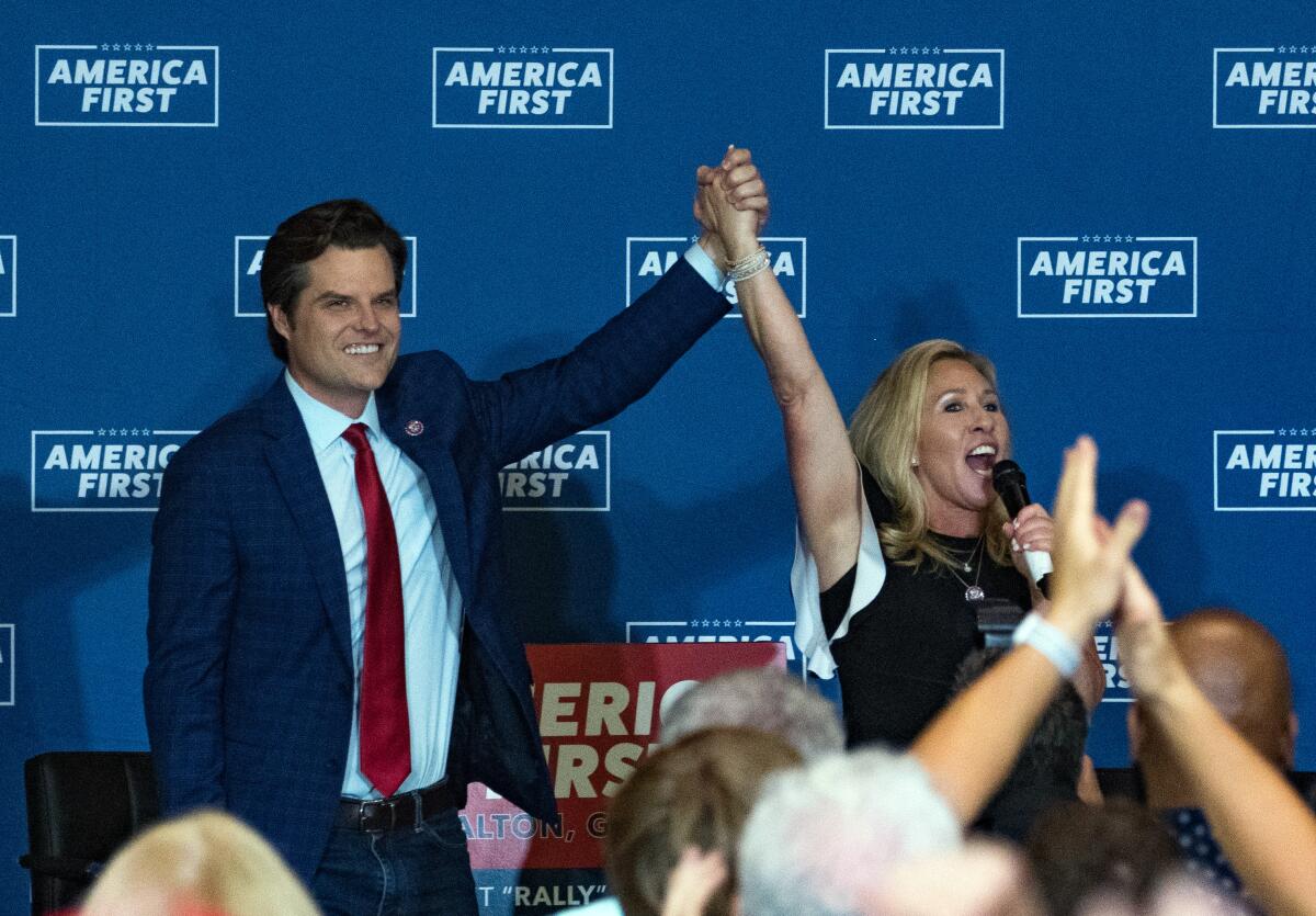 Marjorie Taylor Greene and Matt Gaetz  speak at a rally