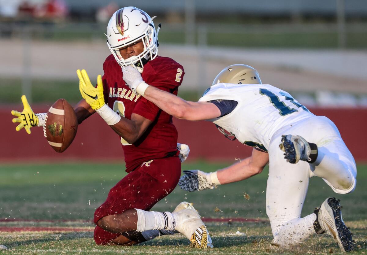 Notre Dame safety Jonas Baklayan briefly grabs the facemark of Bishop Alemany receiver Kevin Green on an incomplete pass.