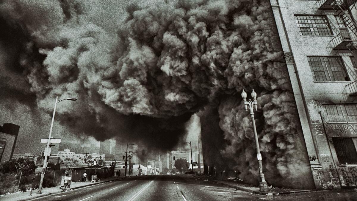 A building at 7th Street and Union Avenue in Los Angeles goes up in flames during the 1992 riots, the subject of an exhibition at the California African American Museum. (Ted Soqui)