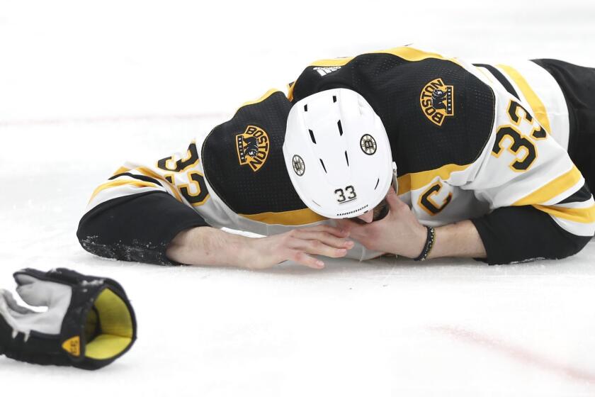Boston Bruins defenseman Zdeno Chara, of Slovakia, lies on the ice after getting hit in the face with the puck during the second period of Game 4 of the NHL hockey Stanley Cup Final against the St. Louis Blues Monday, June 3, 2019, in St. Louis. (AP Photo/Jeff Roberson)