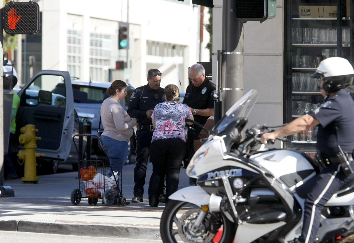 These two women who walked across on a red hand at Brand and Americana Way got a ticket during Glendale Police Dept. pedestrian violations enforcement operation in Glendale on Thursday, Nov. 14, 2013.