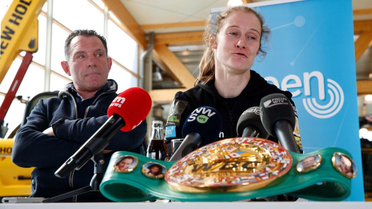 Coach Filiep Tampere and Delfine Persoon sit together during a press conference prior to her upcoming fight against Katie Taylor on April 15. - Persoon will fight Taylor in New York on Saturday.