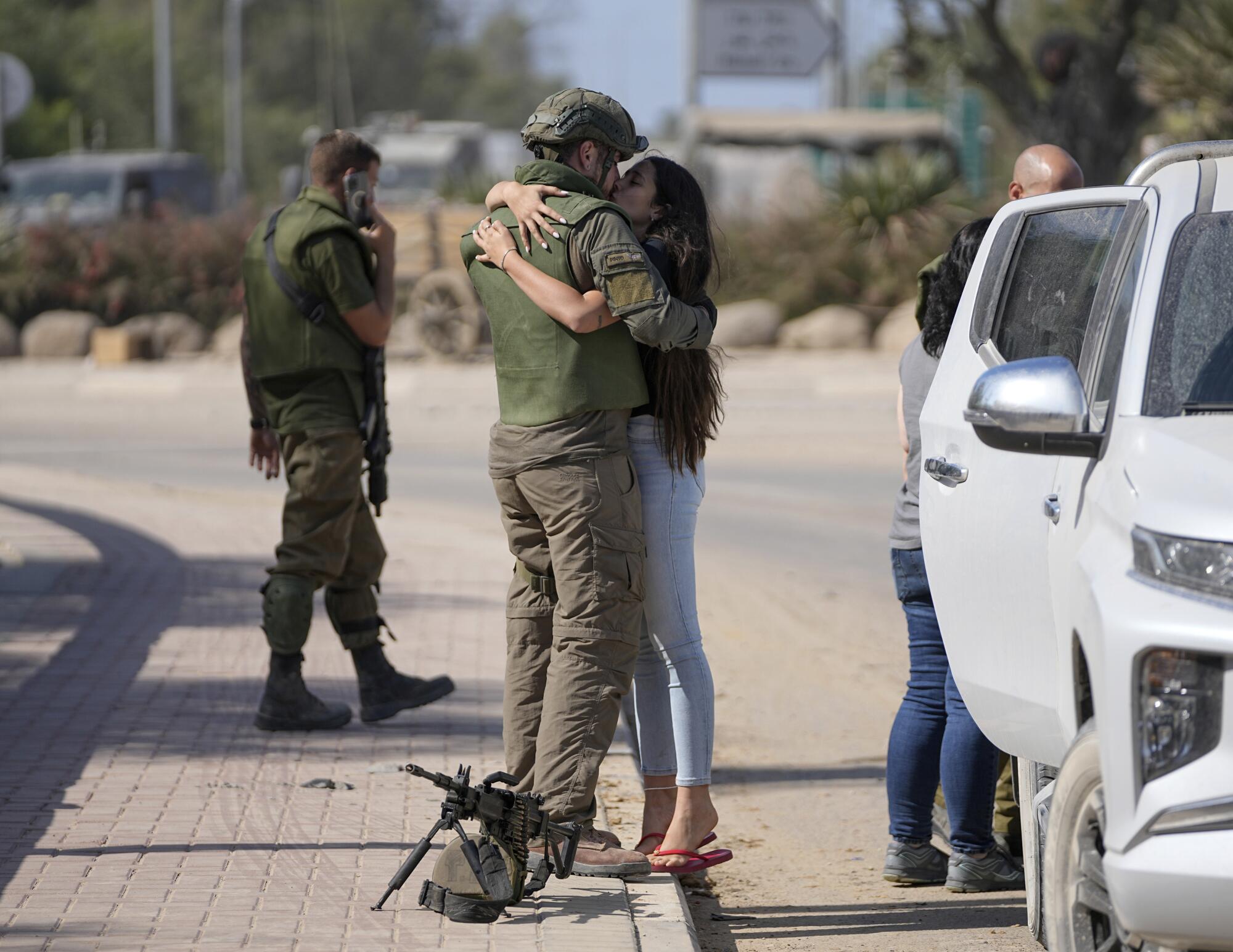 Israeli soldier kissing his partner near the border with Gaza.
