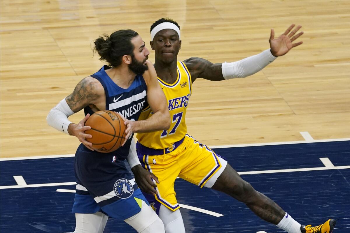 The Minnesota Timberwolves' Ricky Rubio drives around the Lakers' Dennis Schroder.