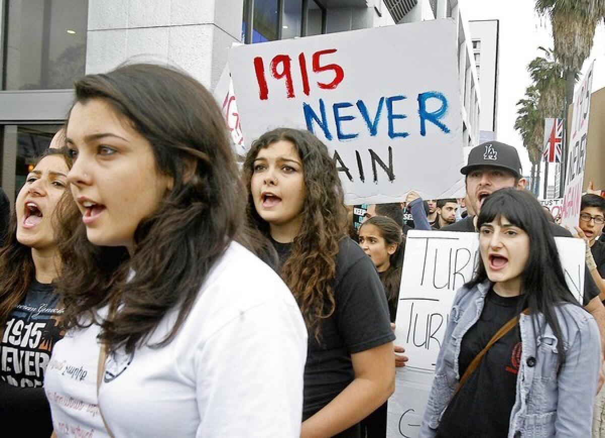 A group of girls walk with a few thousand protestors in a long revolving line at a protest rally in front of the Turkish Consulate demanding an end of Armenian genocide denial by Turkey in Los Angeles on Wednesday, April 24, 2013. A few thousand attended the rally organized by the Armenian Youth Federation.
