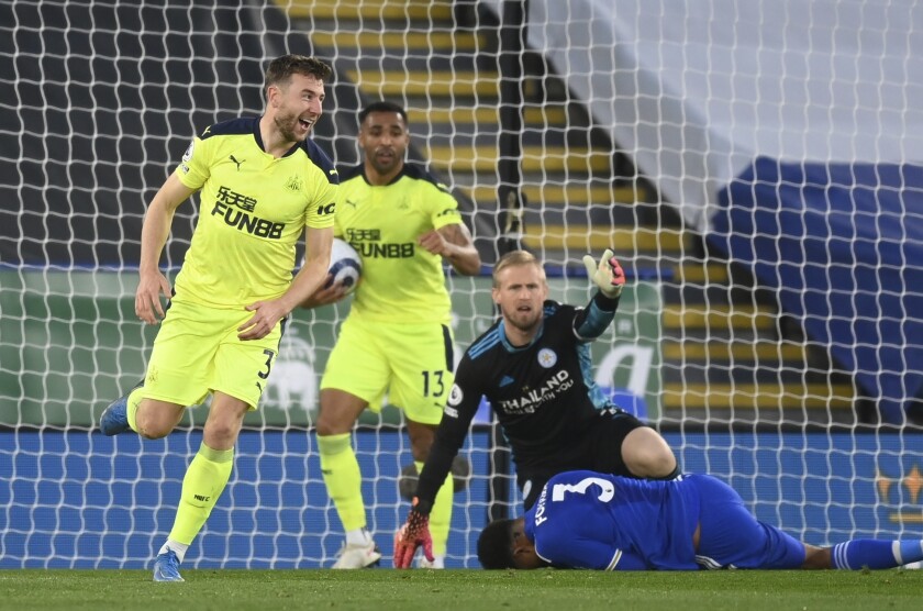 Newcastle's Paul Dummett, left, celebrates after scoring his side's second goal during the English Premier League soccer match between Leicester City and Newcastle United at the King Power Stadium in Leicester, England, Friday, May 7, 2021.Michael Regan/Pool via AP)
