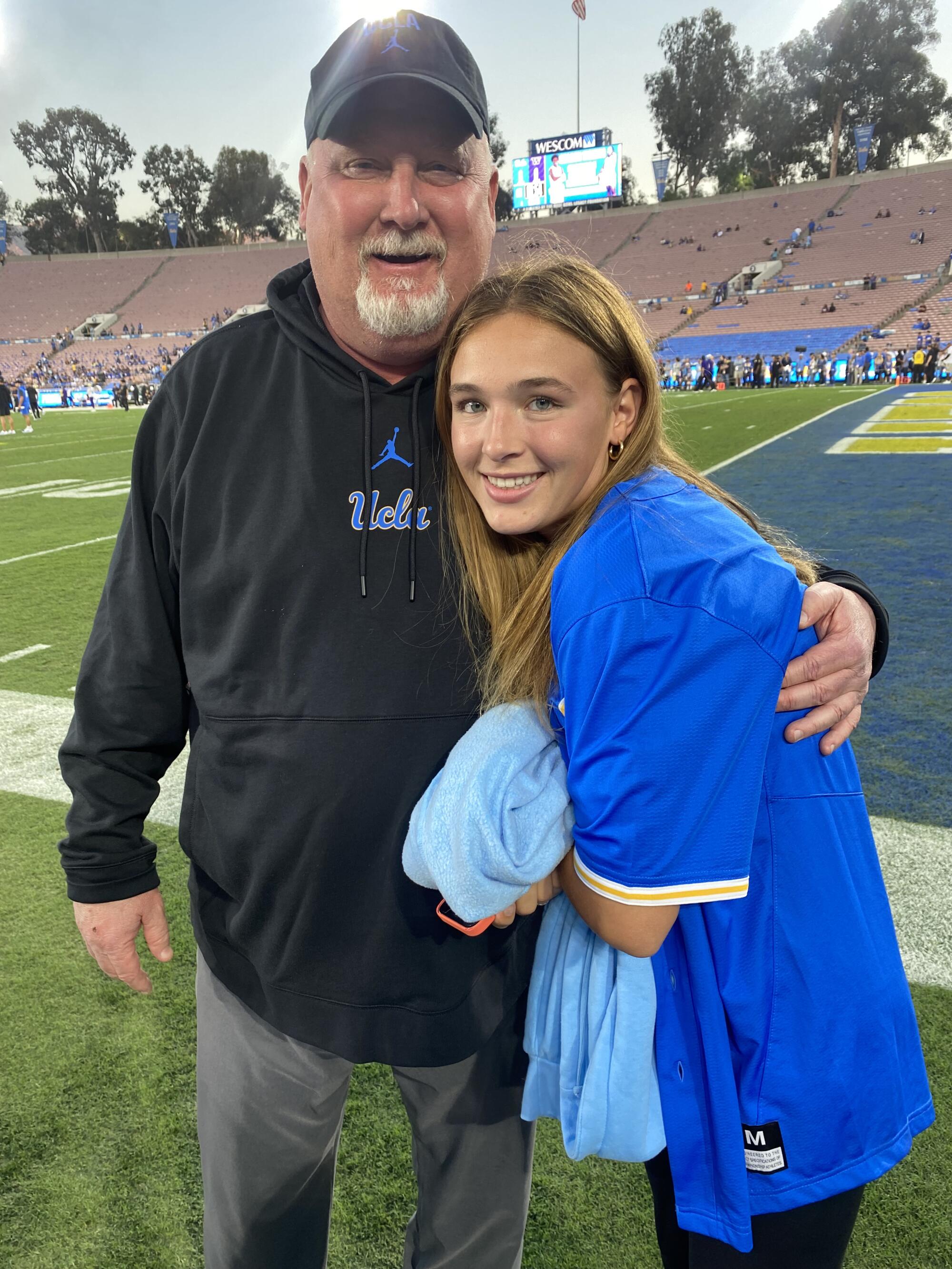 MacKenzie McGovern hugs her father, Bill, during a UCLA game at the Rose Bowl.
