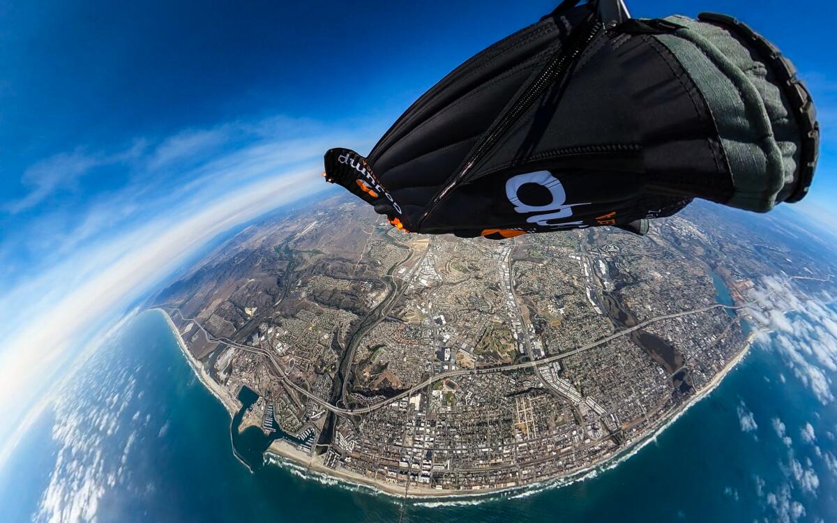 Skydiver Chris Geiler of Oceanside soaring high above Oceanside in his wingsuit.