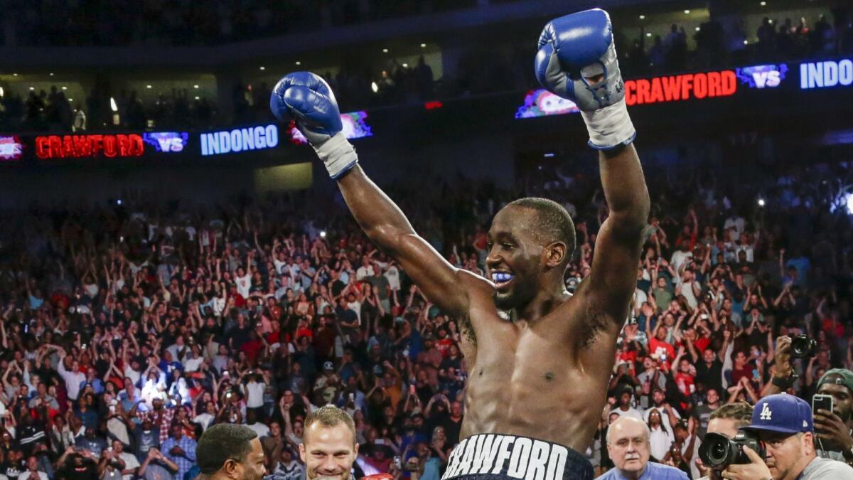 Terence Crawford celebrates his win by knockout against Julius Indongo in the third round of a junior welterweight world title unification bout in Lincoln, Neb. on Aug. 19, 2017.