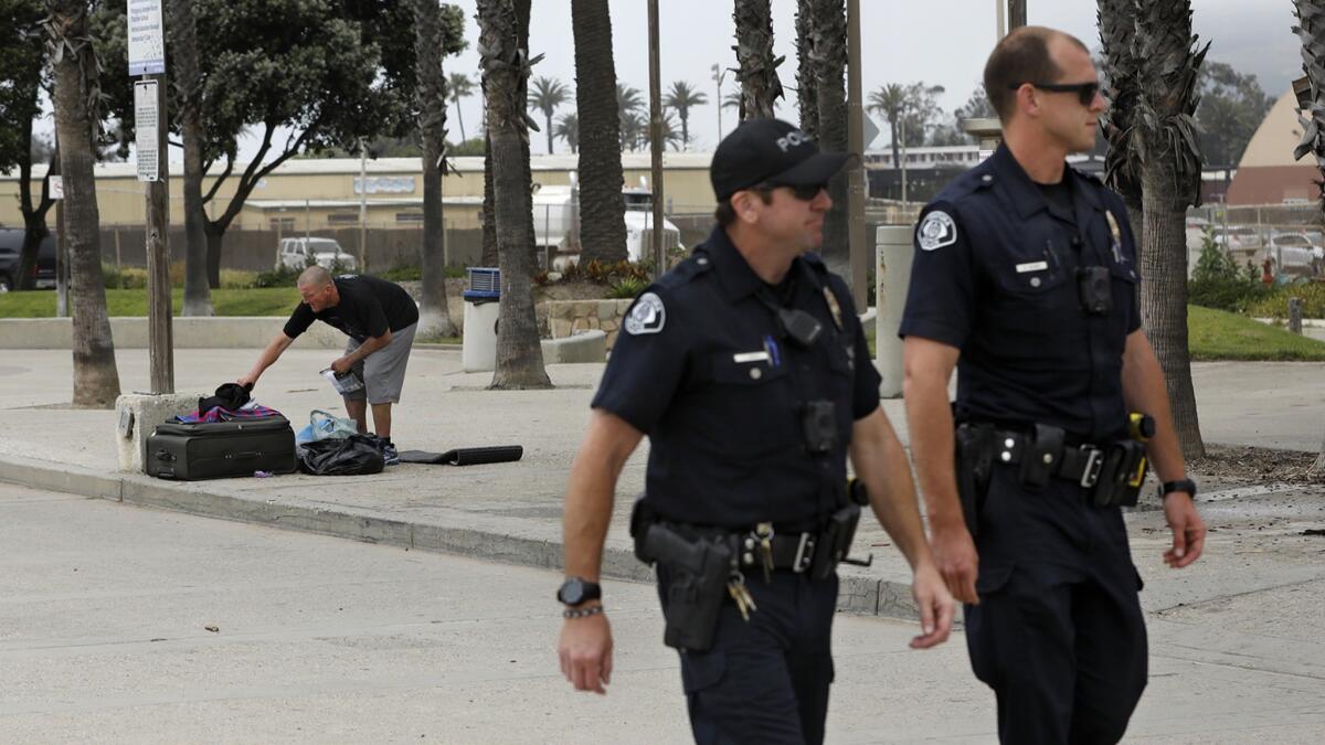 Ventura police officers Tim Davis, left, and Schuyler Heard patrol the Ventura boardwalk on Monday.
