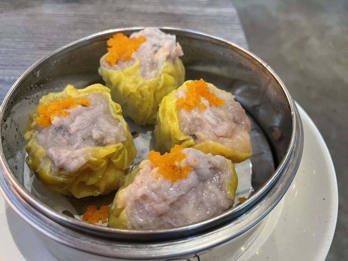 A dim sum steamer holds four shumai.