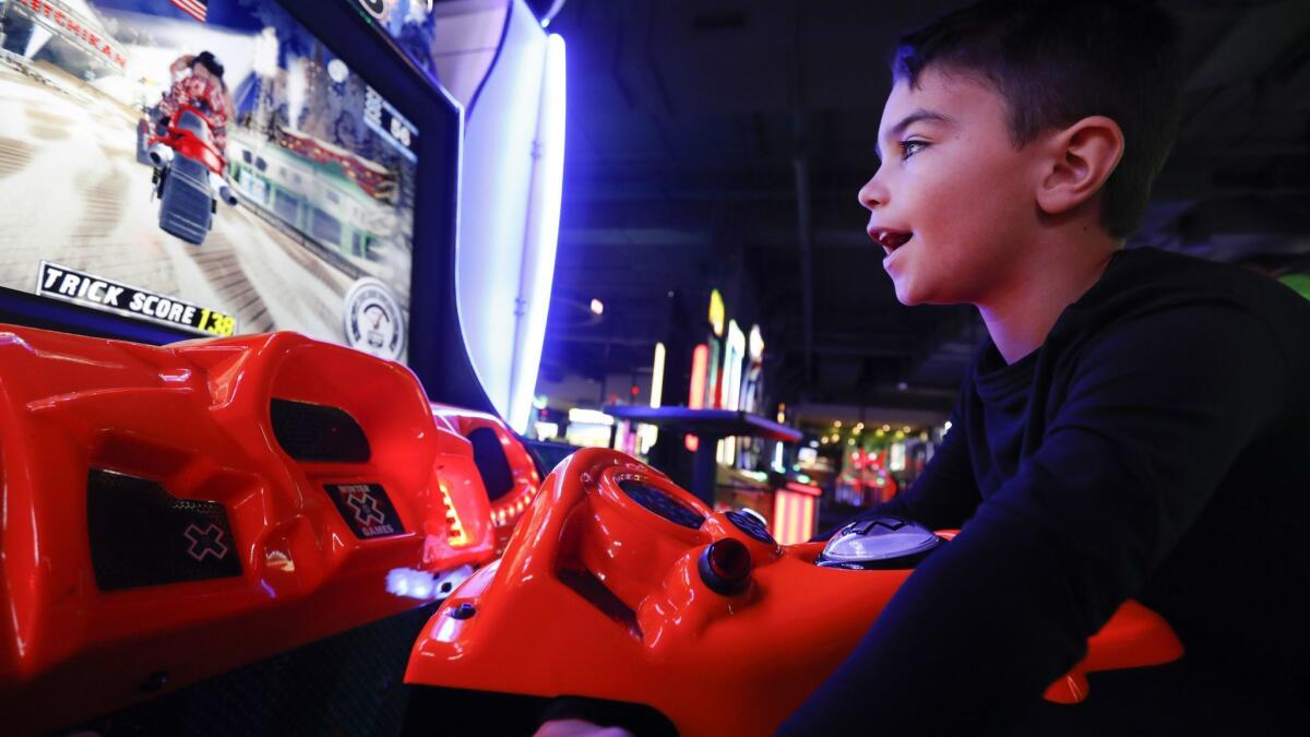 Sean Branch, 7, a first-grader at Beckford Avenue Elementary School in Northridge, enjoys the arcade game "SnoCross" at Dave and Buster's arcade in Northridge instead of being in school because of the teachers' strike.