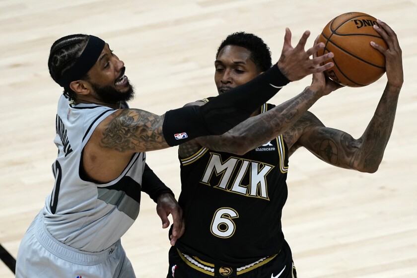 Atlanta Hawks guard Lou Williams (6) is defended by Portland Trail Blazers forward Carmelo Anthony (00) as he looks for an opening in the first half of an NBA basketball game Monday, May 3, 2021, in Atlanta. (AP Photo/John Bazemore)