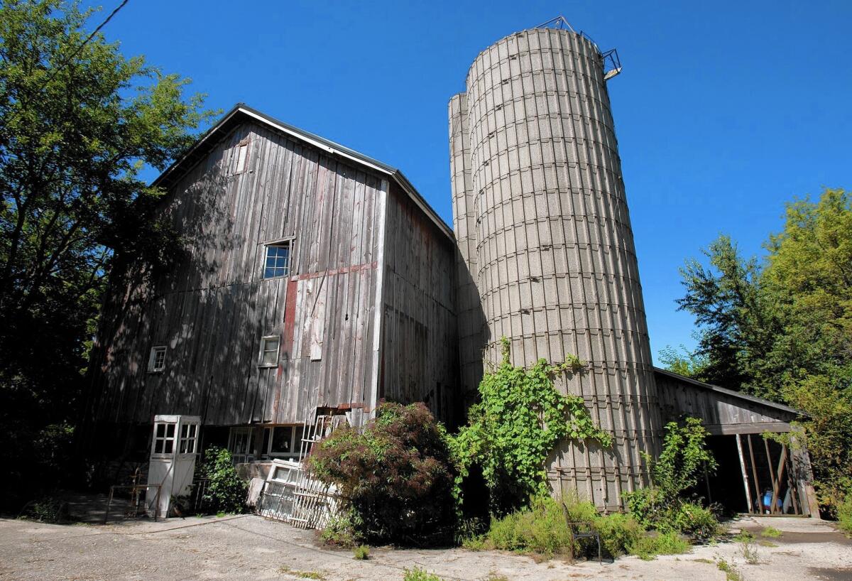 Paul and Josie Hopkins of Maple Park, Ill., are restoring this 1838 barn, one of their many projects.