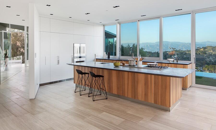 The kitchen has an island and views of the outdoors.