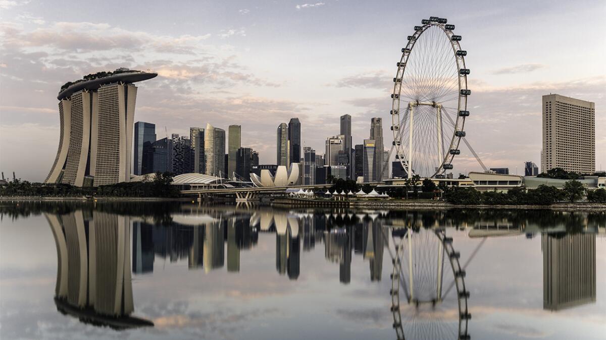 Singapore skyline at dawn. A round-trip fare on United is less than $650, but the booking window is short.