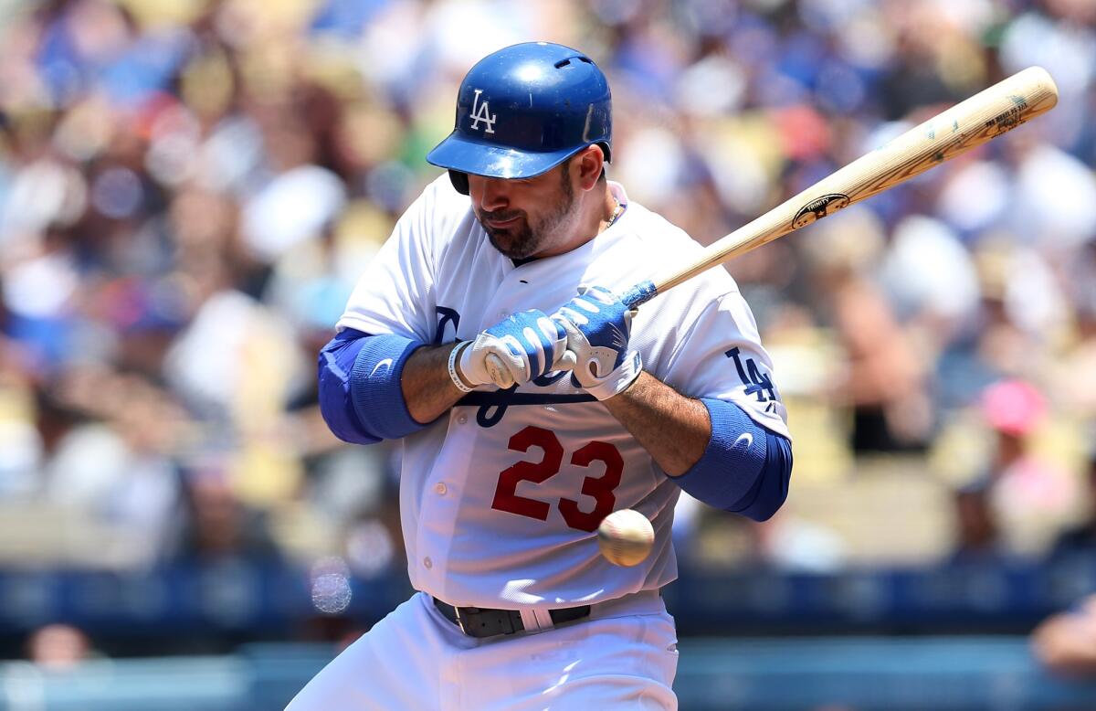 Adrian Gonzalez is hit by a pitch during Sunday's loss to the Mets.