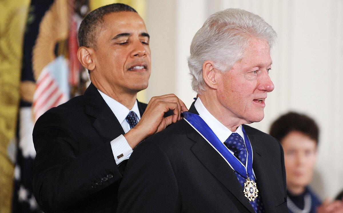President Obama awards the Presidential Medal of Freedom to former President Bill Clinton in the East Room of the White House.