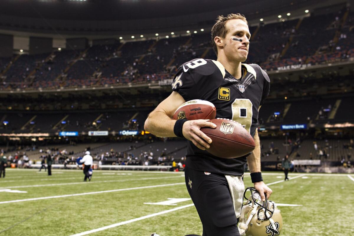 Quarterback Drew Brees of the New Orleans Saints jogs off the field after defeating the Carolina Panthers.