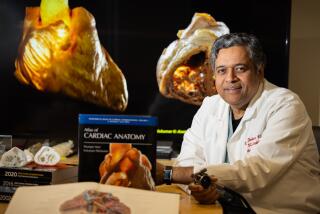 Westwood, CA - May 09: Dr. Kalyanam Shivkumar, Professor of Medicine, UCLA Cardiac Arrhythmia Center, shown with his book book titled "Atlas of Cardiac Anatomy" and a book by Dr. Eduard Pernkopf, an ardent Nazi whose anatomical book was drawn off the bodies of executed prisoners, shown in foreground. Dr. Kalyanam Shivkumar and others in the Amara Yad project are working to create a new set of anatomical images. Shivkumar wants their work to surpass that of Dr. Eduard Pernkopf, an ardent Nazi whose anatomical book was drawn off the bodies of executed prisoners. Photo taken at David Geffen School of Medicine at UCLA in Westwood Thursday, May 9, 2024. (Allen J. Schaben / Los Angeles Times)