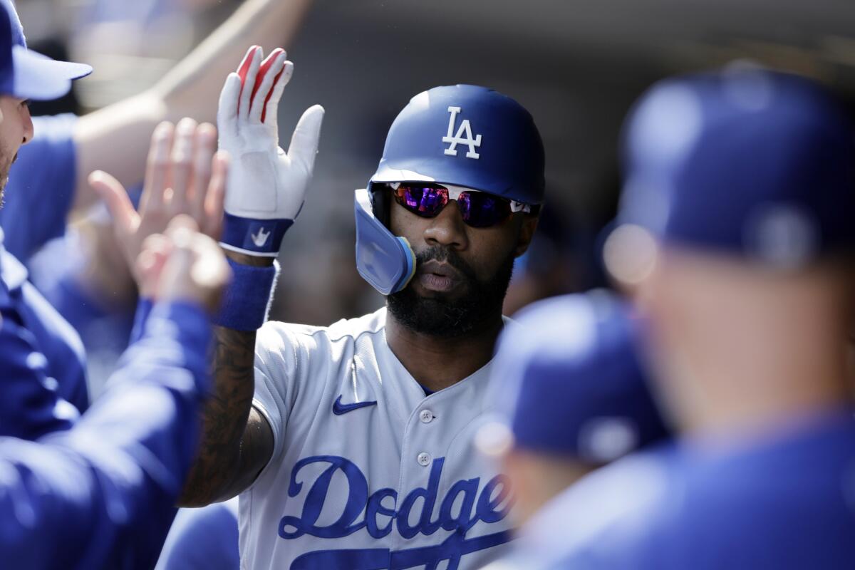 The Dodgers' Jason Heyward is congratulated in the dugout after hitting a solo home run in the first inning Sunday.