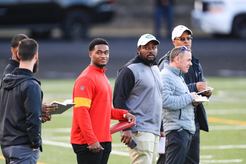 NFL scouts and team representatives watch quarterback Colin Kaepernick.