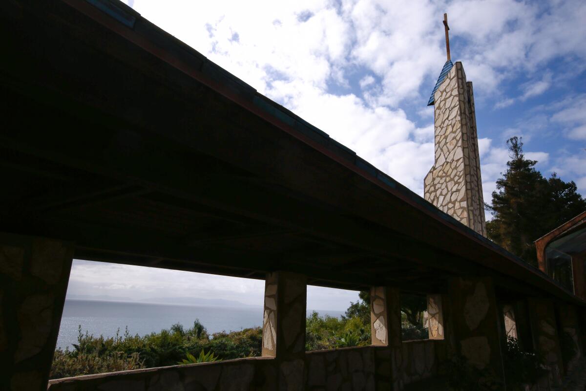 A church bell tower overlooking the ocean.