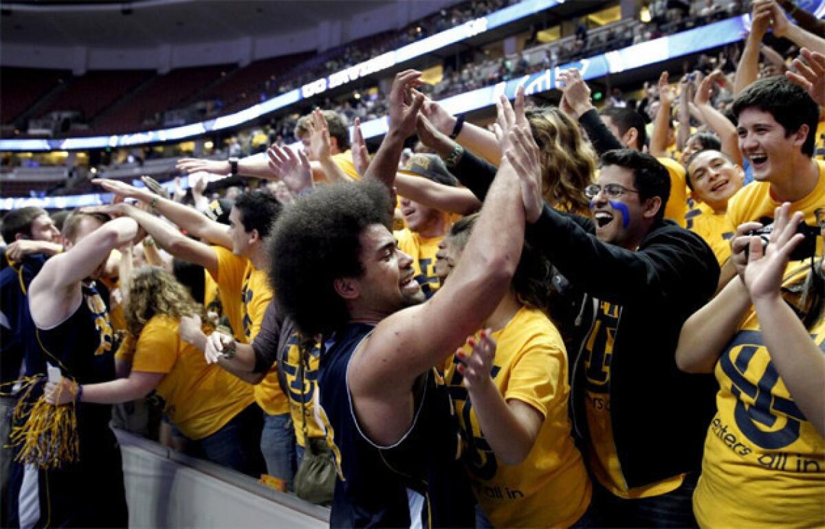 UC-Irvine fans celebrate with center John Ryan, left, and swingman Michael Wilder after the Anteaters 67-60 win over Long Beach State.