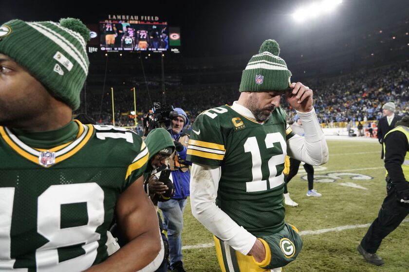 Green Bay Packers quarterback Aaron Rodgers (12) stands on the field following an NFL football game against the Detroit Lions Sunday, Jan. 8, 2023, in Green Bay, Wis. The Lions won 20-16. (AP Photo/Morry Gash)