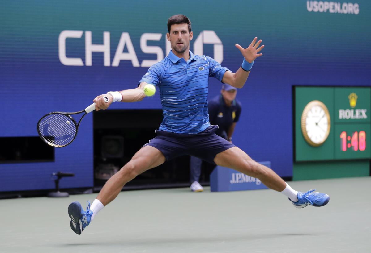Novak Djokovic returns a shot during his first-round victory over Roberto Carballes Baena at the U.S. Open on Monday.