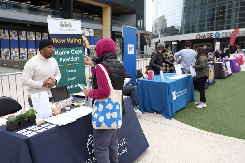 SAN FRANCISCO, CALIFORNIA - JUNE 03: A job seeker meets with a recruiter during the Healthcare Academy career and training fair outside of the Chase Center on June 03, 2022 in San Francisco, California. The Healthcare Academy held a career and training fair as employers added 390,000 jobs in May, according to the Bureau of Labor Statistics. The national unemployment rate remains at 3.6 percent. (Photo by Justin Sullivan/Getty Images)