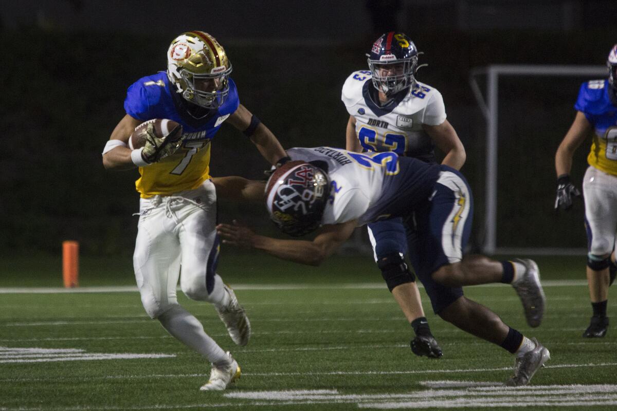 San Juan Hills' Austin Hogan breaks a tackle attempt during the Orange County North vs. South All-Star Classic on Saturday.