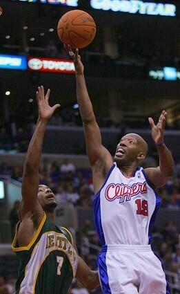 Sam Cassell, right, drives to the hoop as Seattle SuperSonics Rashard Lewis tries to defend.
