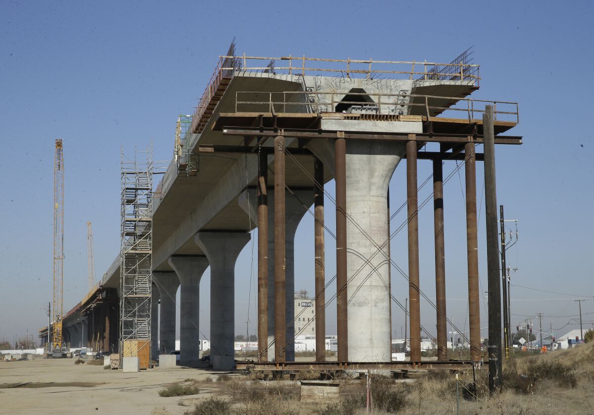 An elevated section of rail line under construction.