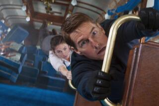 Stop this crazy thing — Superspy Ethan Hunt (Tom Cruise, foreground) and thief Grace (Hayley Atwell) hang on for dear life in the epic train-crash set piece that concludes "Mission: Impossible — Dead Reckoning Part One."