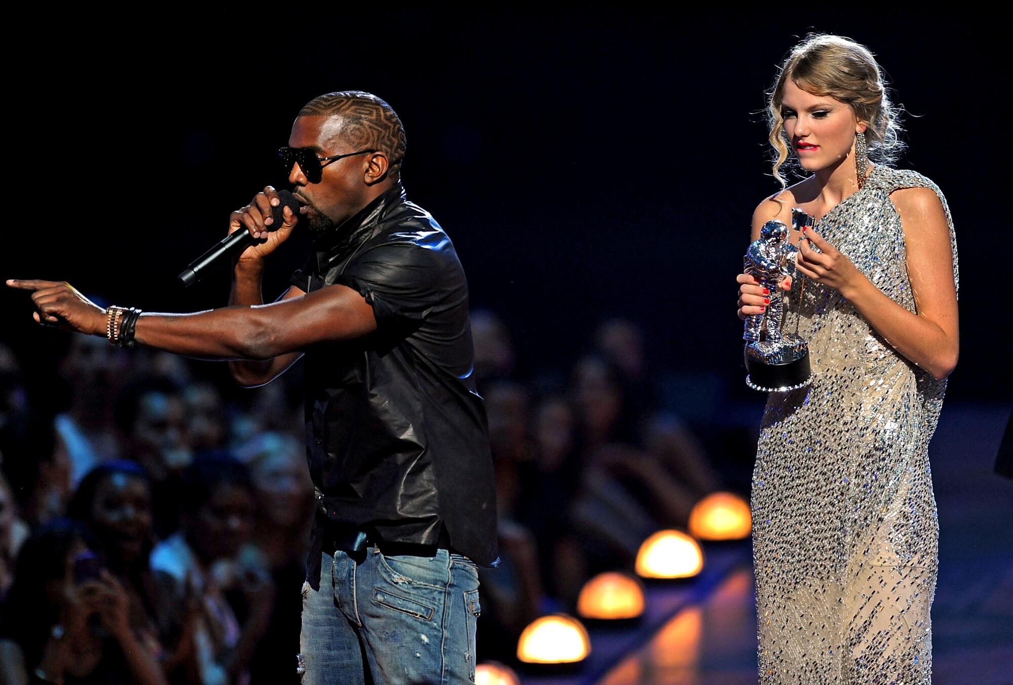 A male rap star interrupts a female pop star onstage at an awards show. 